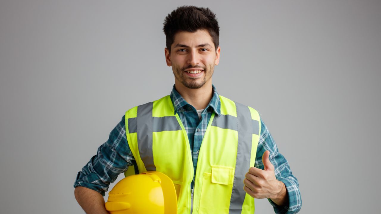 Safety engineer wearing a protective suit and safety helmet, inspecting workplace for safety compliance