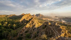 Ancient Aravalli mountain range in India showing weathered rocky hills and signs of environmental degradation due to mining.