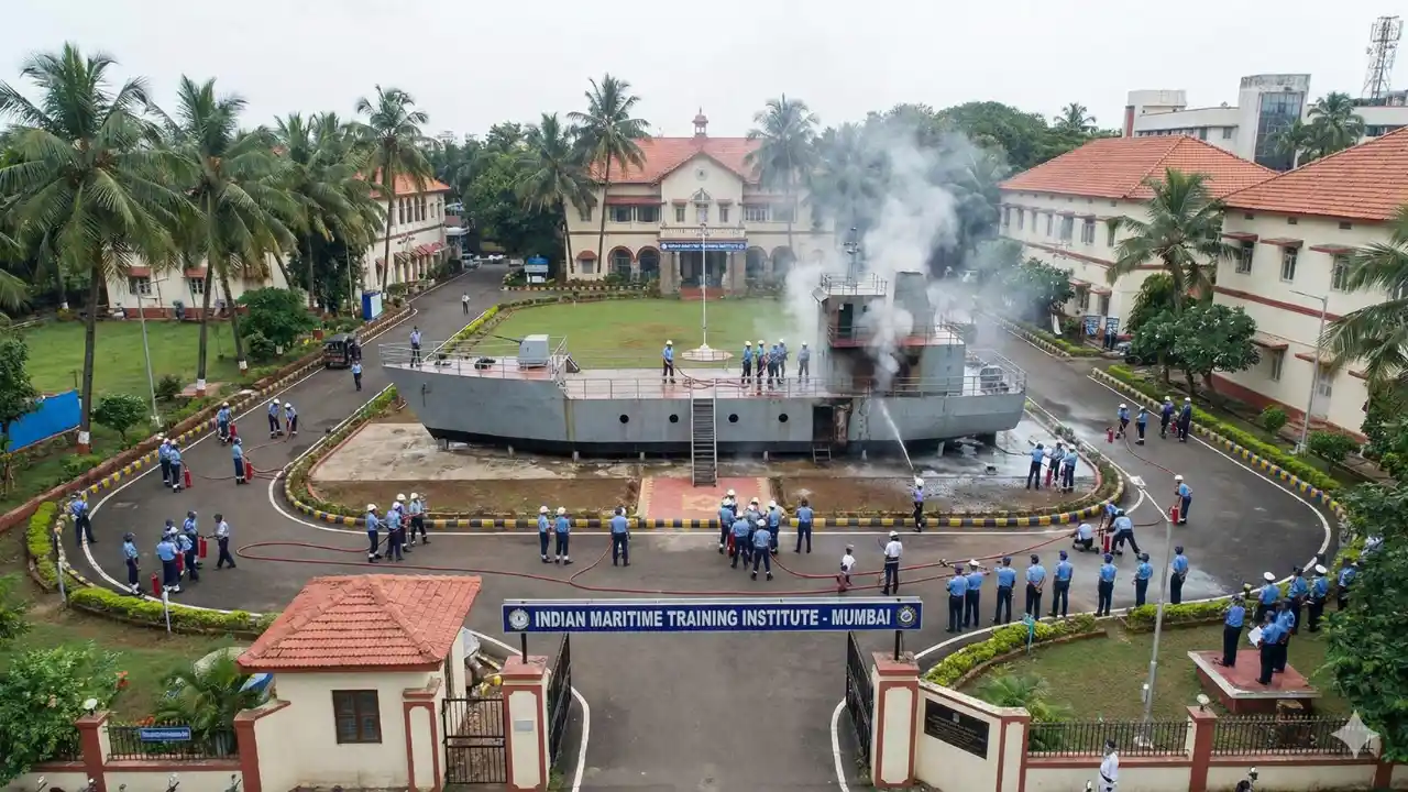 Indian maritime training institute campus view with students in uniform performing a fire fighting drill on a ship-in-campus model.